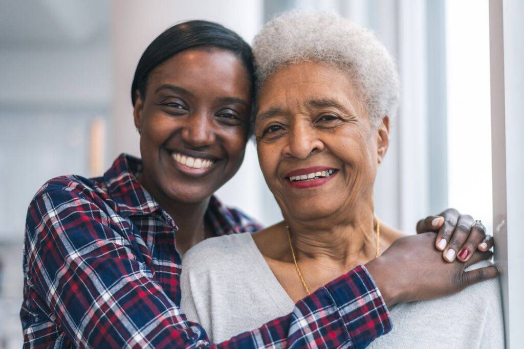 Younger woman hugging an older woman